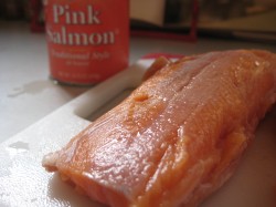 Canned salmon and a fresh salmon fillet ready for poaching